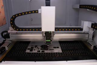 Machine de découpe laser au-dessus d'une tôle découpée